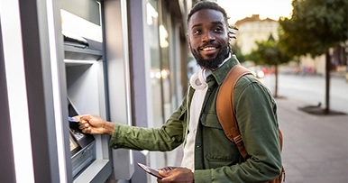 man using atm to make a withdrawal