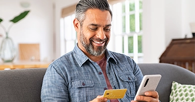cardswap man holding mobile phone and debit card